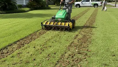 Professional lawn aeration service in New Orleans, LA with machine removing soil plugs for healthier turf